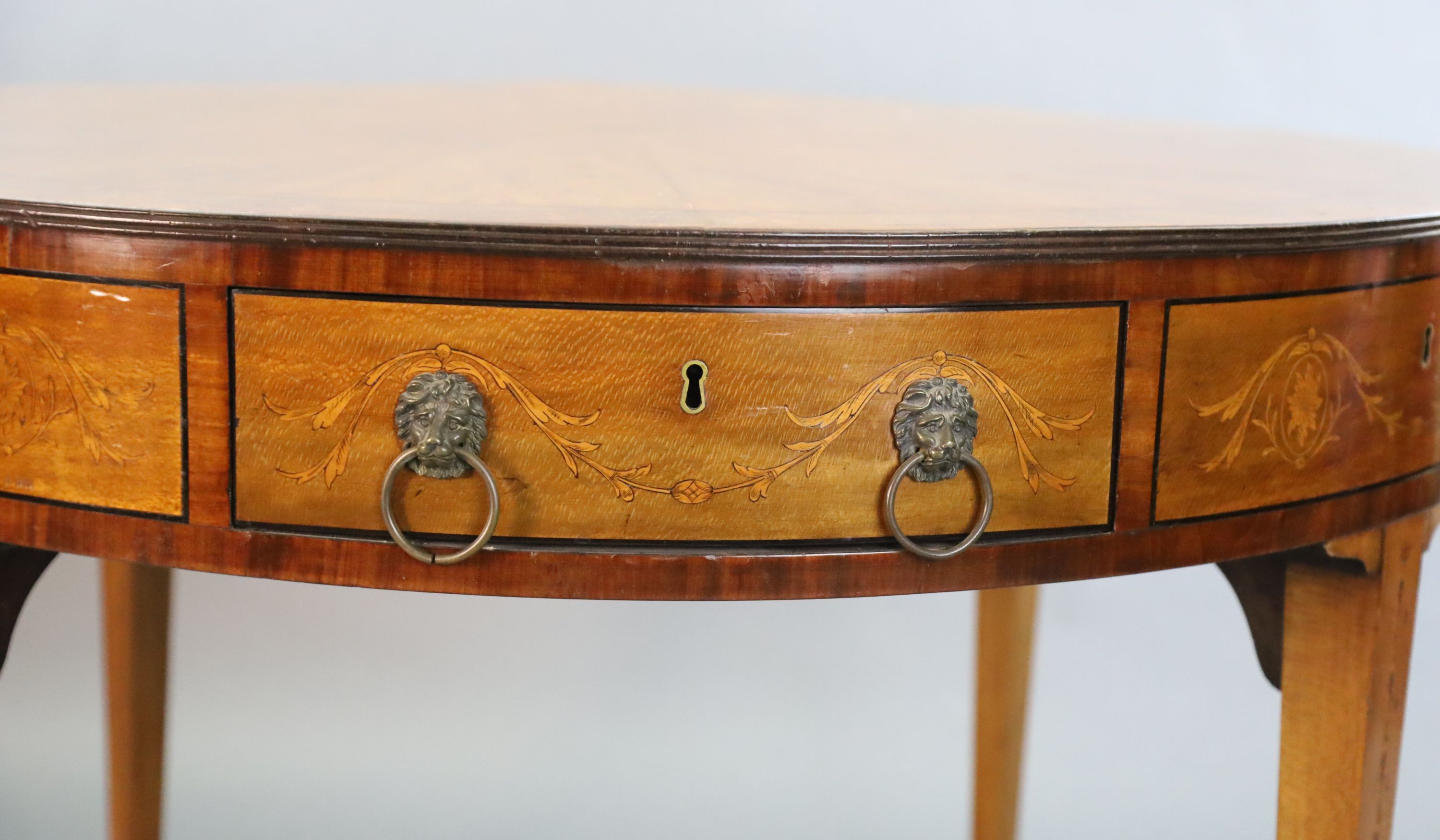 An Edwardian marquetry inlaid satinwood drum top library table, Diam. 3ft 5.5in H.2ft 5.5in.